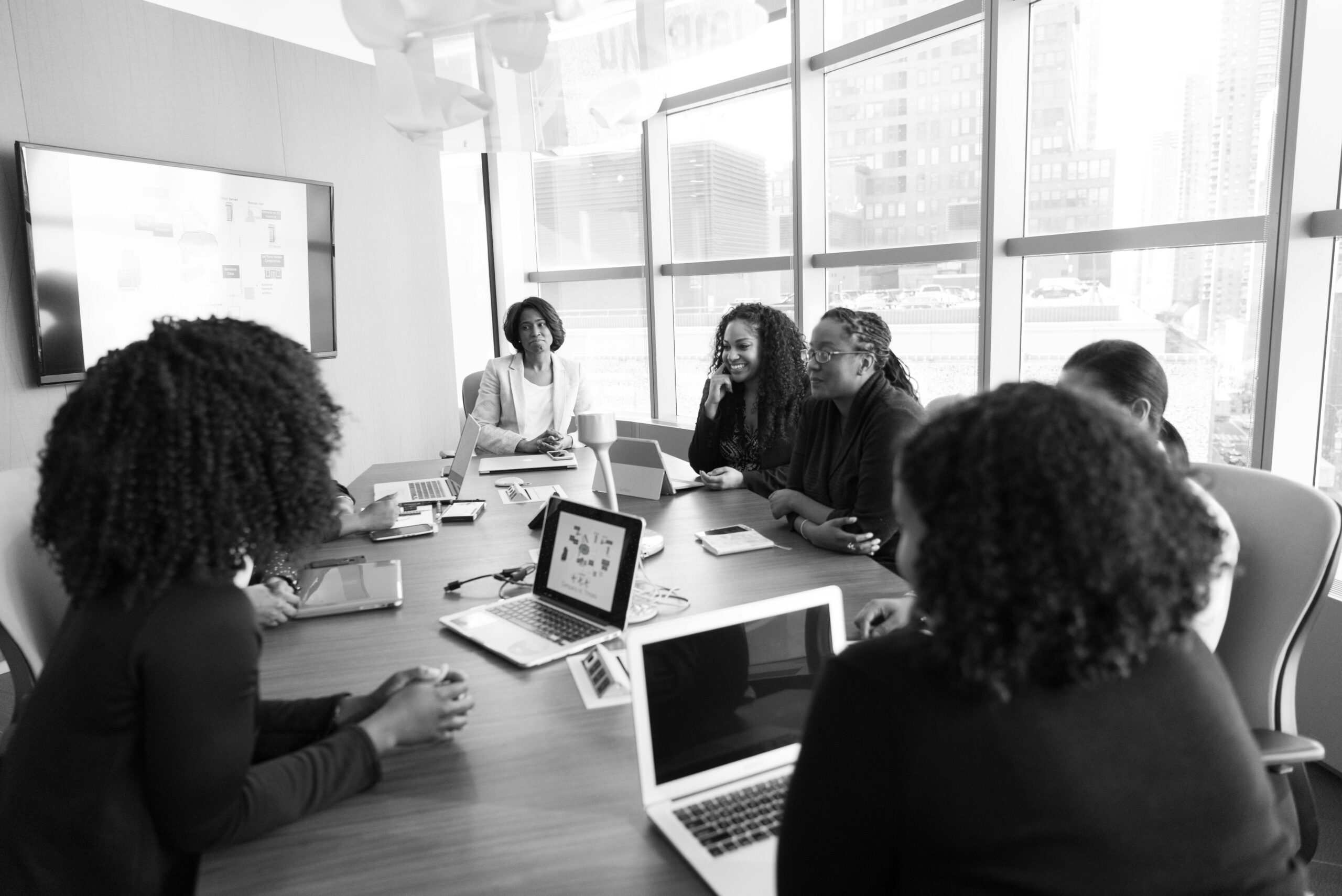 Black women collaborating in a modern office meeting. Engaging and productive work environment.